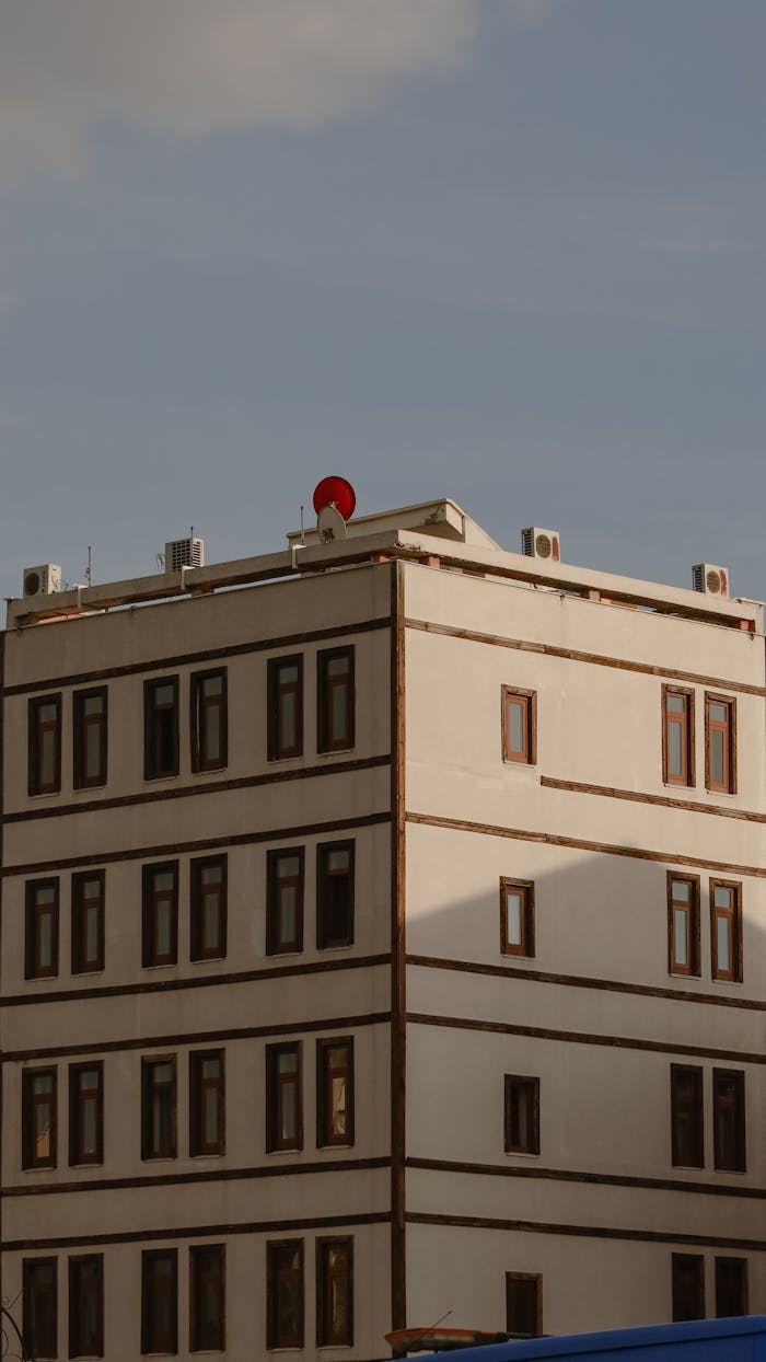 A modern apartment building in Konya, Türkiye, illuminated by warm evening sunlight.